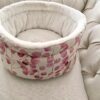 Luxury cuddle cup pet bed with cat resting in a soft cozy nest
