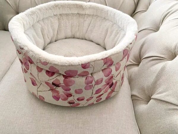 Luxury cuddle cup pet bed with cat resting in a soft cozy nest
