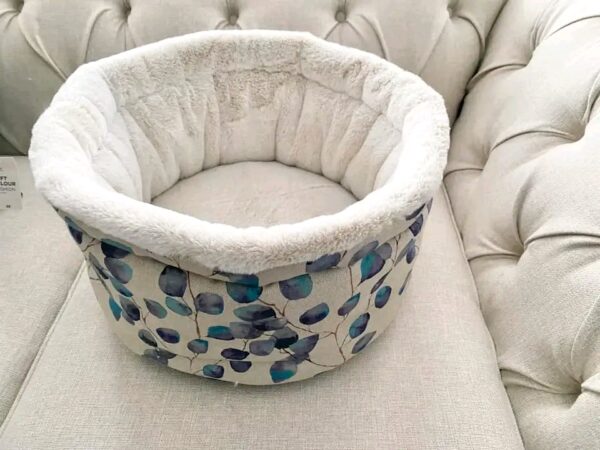 Luxury cuddle cup pet bed with cat resting in a soft cozy nest