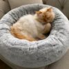 fluffy round pet bed with raised edges for comfort